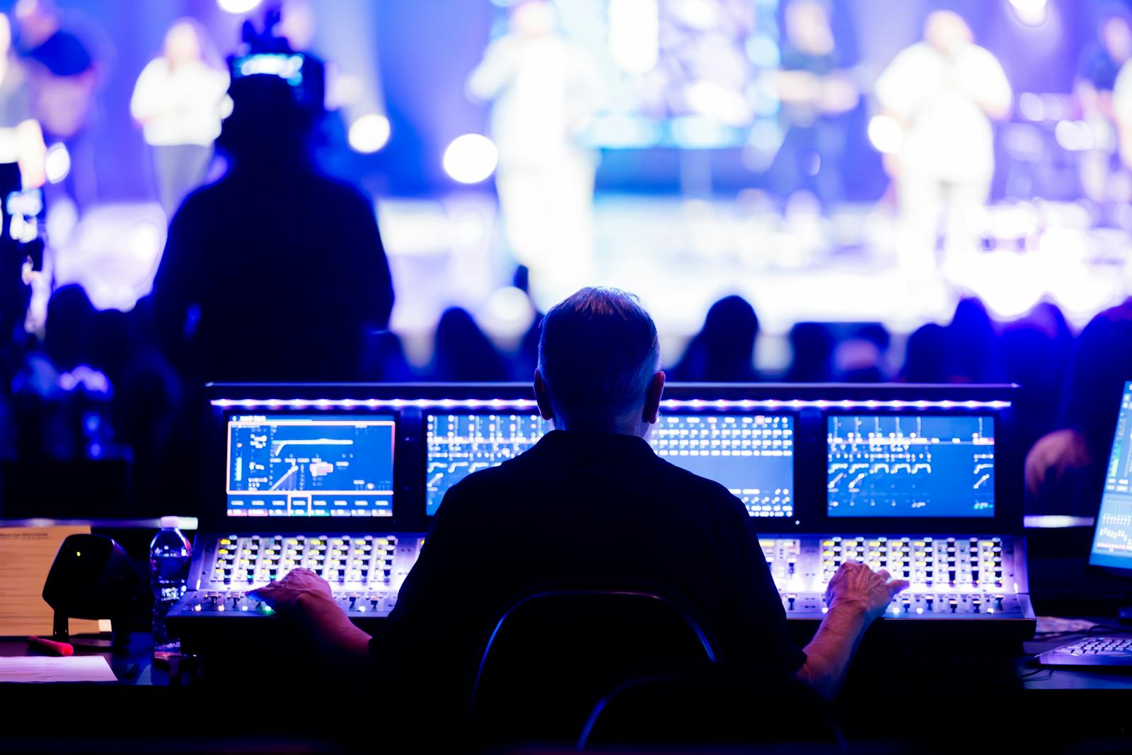 Sound engineer in front of stage during live preparation